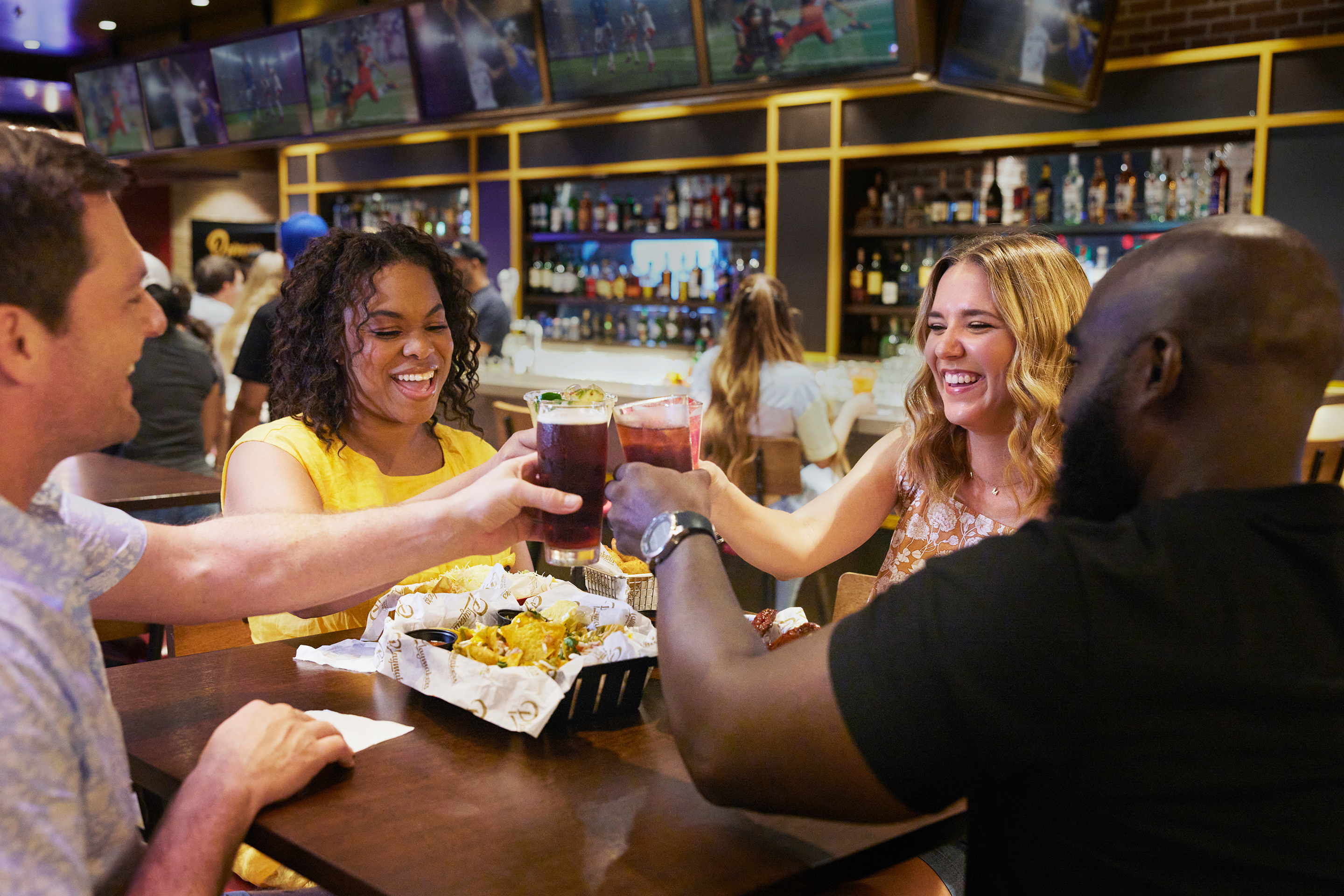 Friends Enjoying the Sports Game at Playmaker's