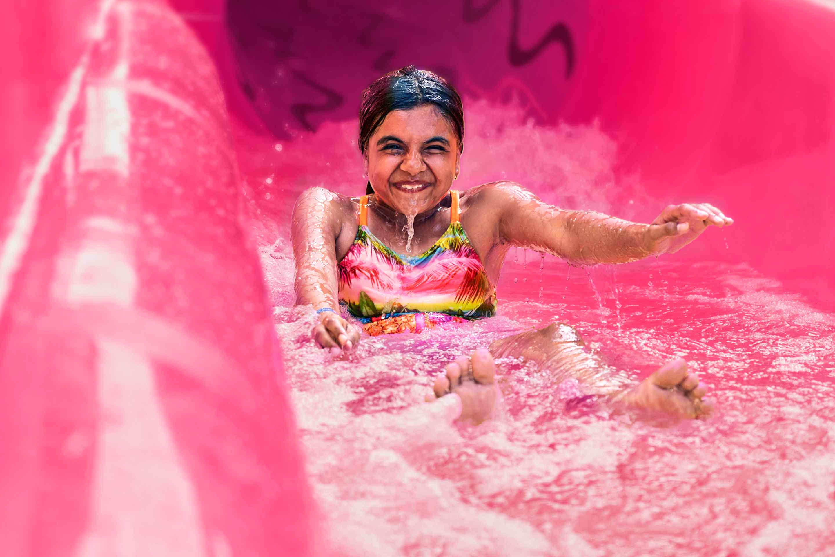 Navigator, girl coming out of a waterslide very happy